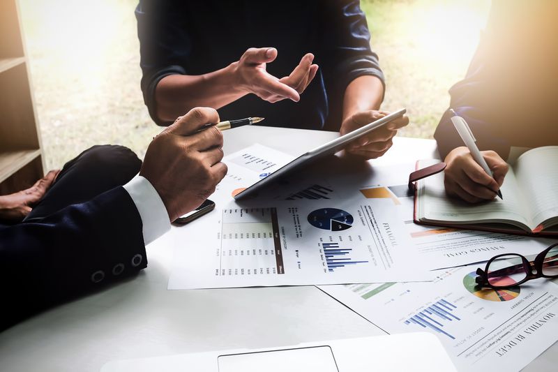 Business people using pen,tablet,notebook are planning a marketing plan.