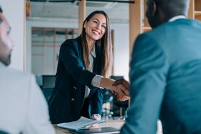 Business people shaking hands in a meeting