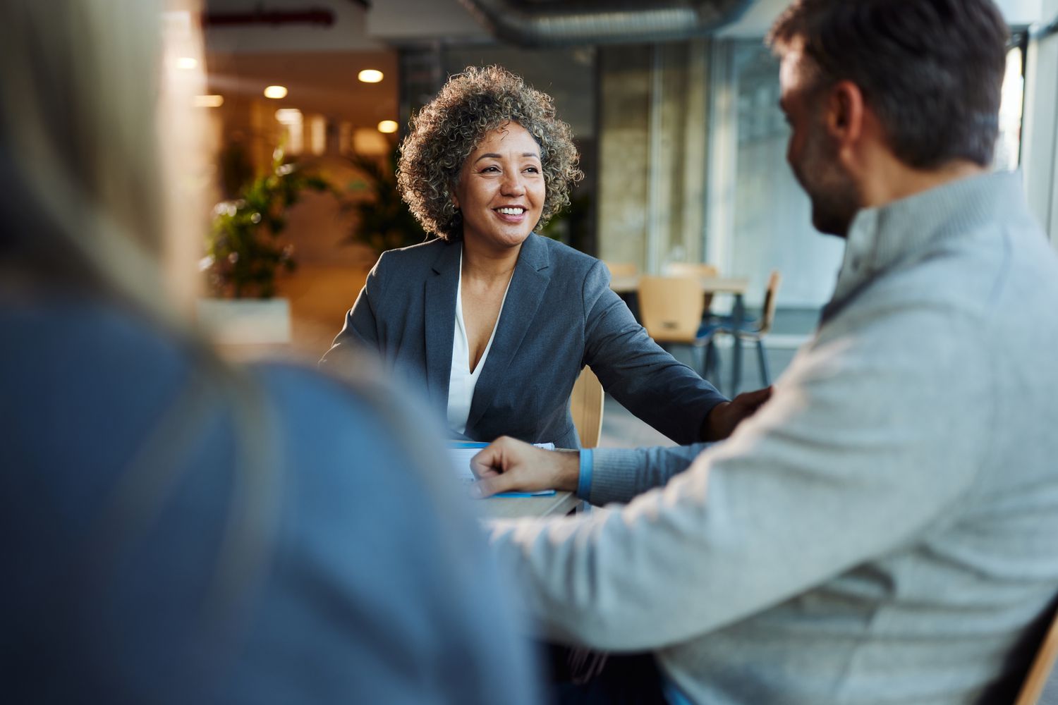 Worker in office with clients