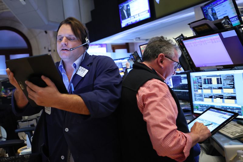  Traders work on the floor of the New York Stock Exchange during morning trading on April 22, 2025.