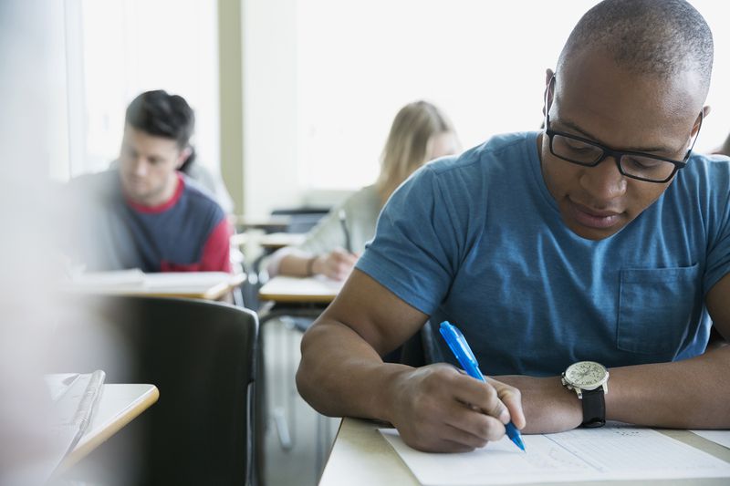Focused College Students Taking Exam in Classroom