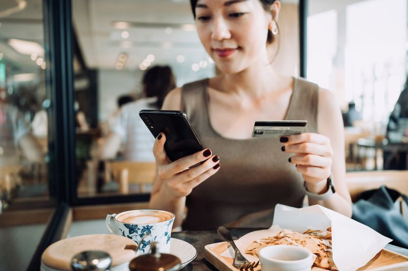 A woman uses a credit card to make a purchase.