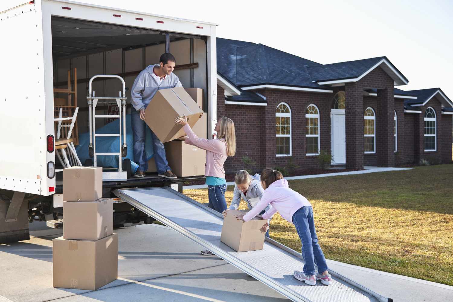 Family moving house, unloading truck 