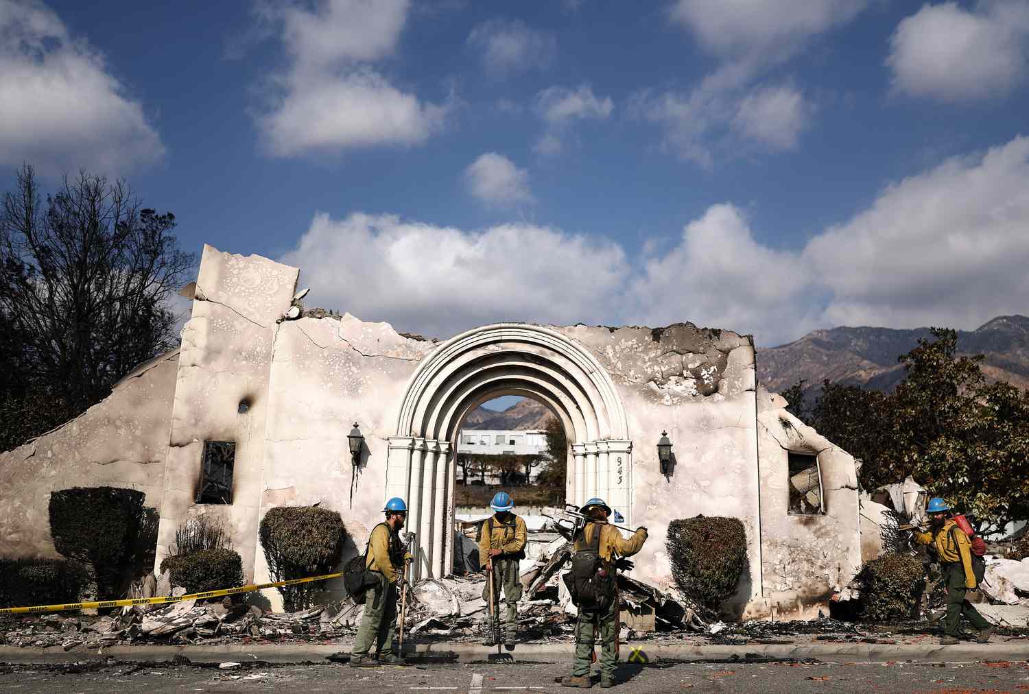 Private firefighters from Oregon gather in front of Altadena Community Church which burned in the Eaton Fire on January 17, 2025 in Altadena, California. 