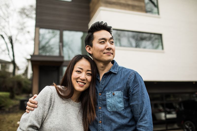 Couple in front of house