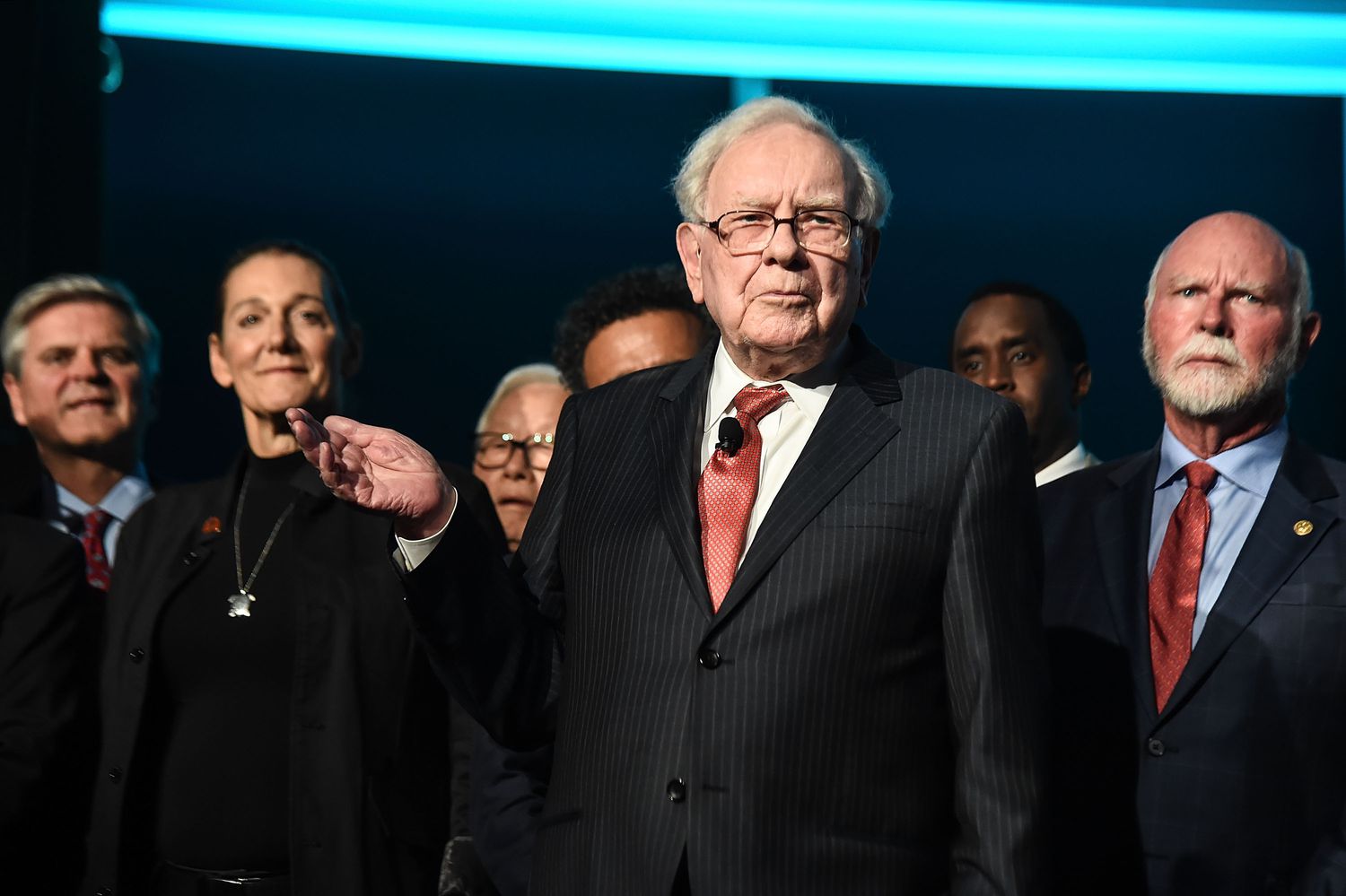 Warren Buffett standing with a group of other business people.