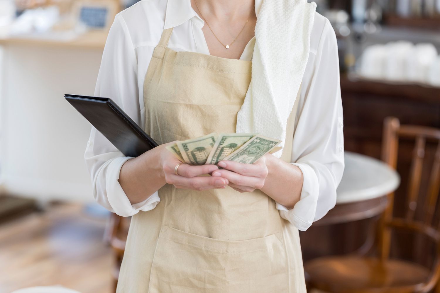 Unrecognizable Coffee Shop Waitress Counts Bill Payment