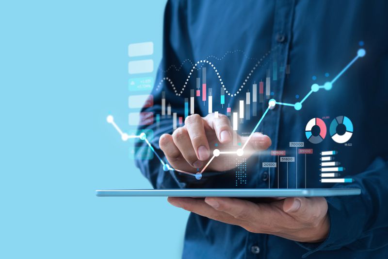 Businessman researching investments on a tablet screen.