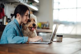 Worker at home with dog