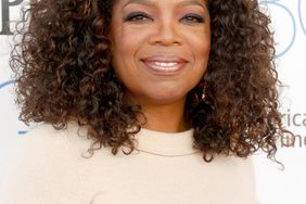 Oprah on red carpet in beige shirt