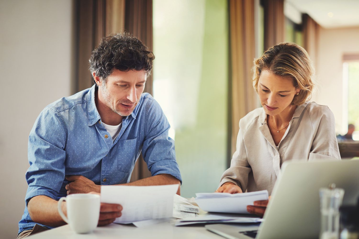 Couple going through their finances at home to find ways to rebuild their credit.