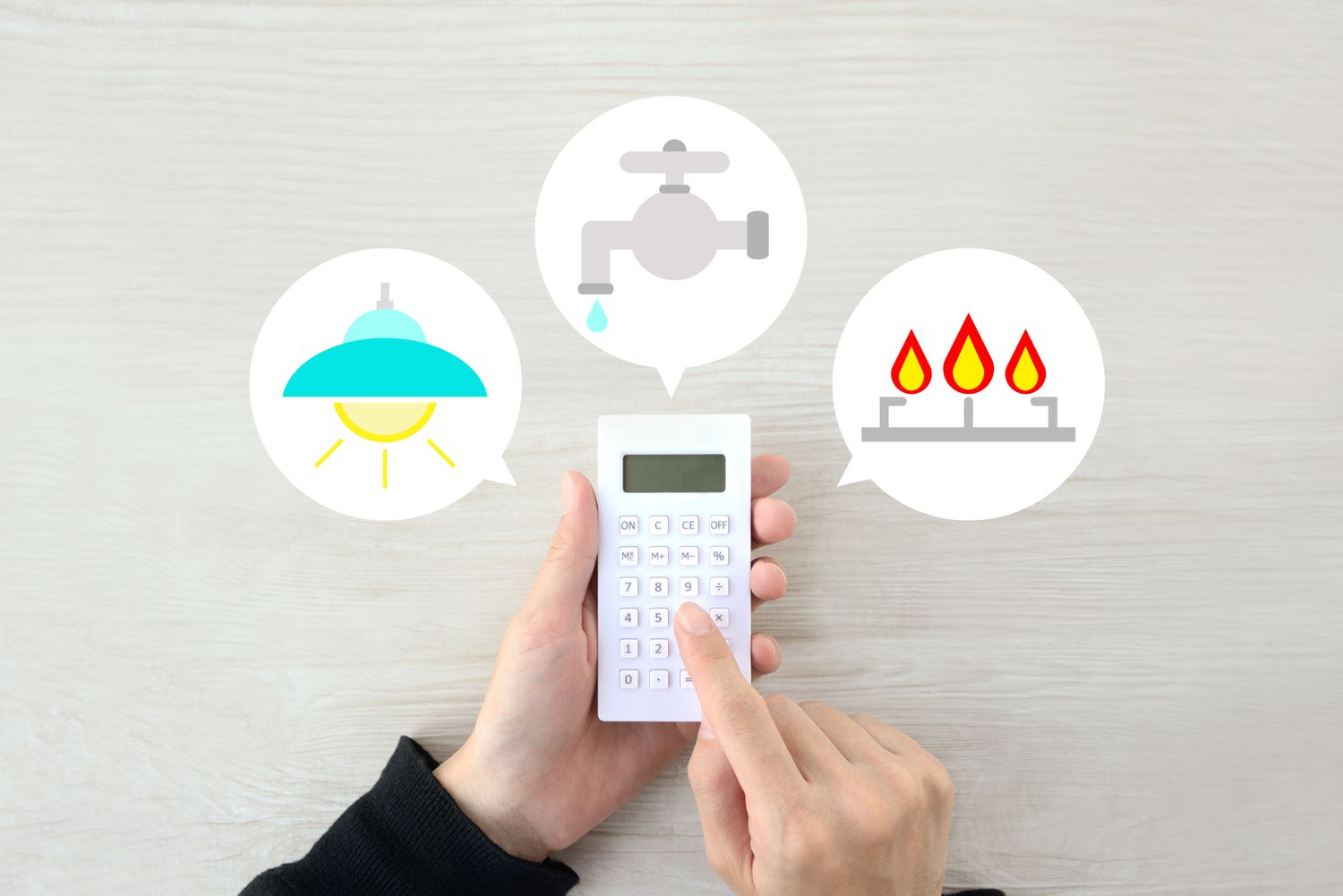 A person using a calculator surrounded by utilities services symbols
