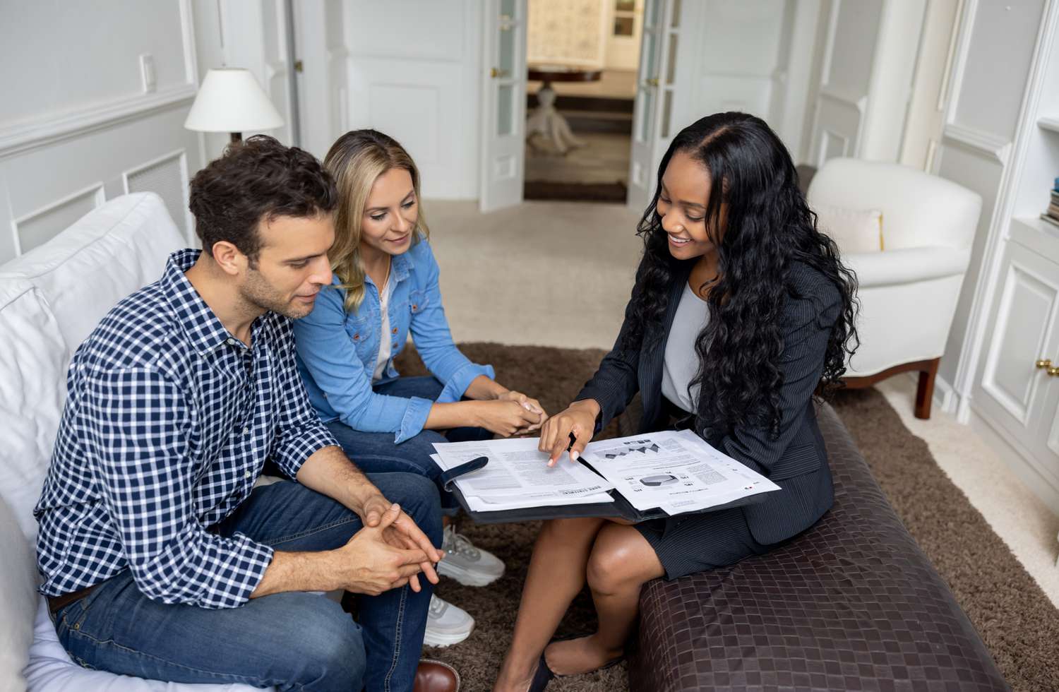 Broker discussing real estate transaction with a couple