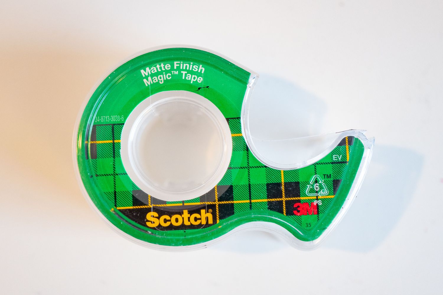 A green and plaid Scotch tape dispenser