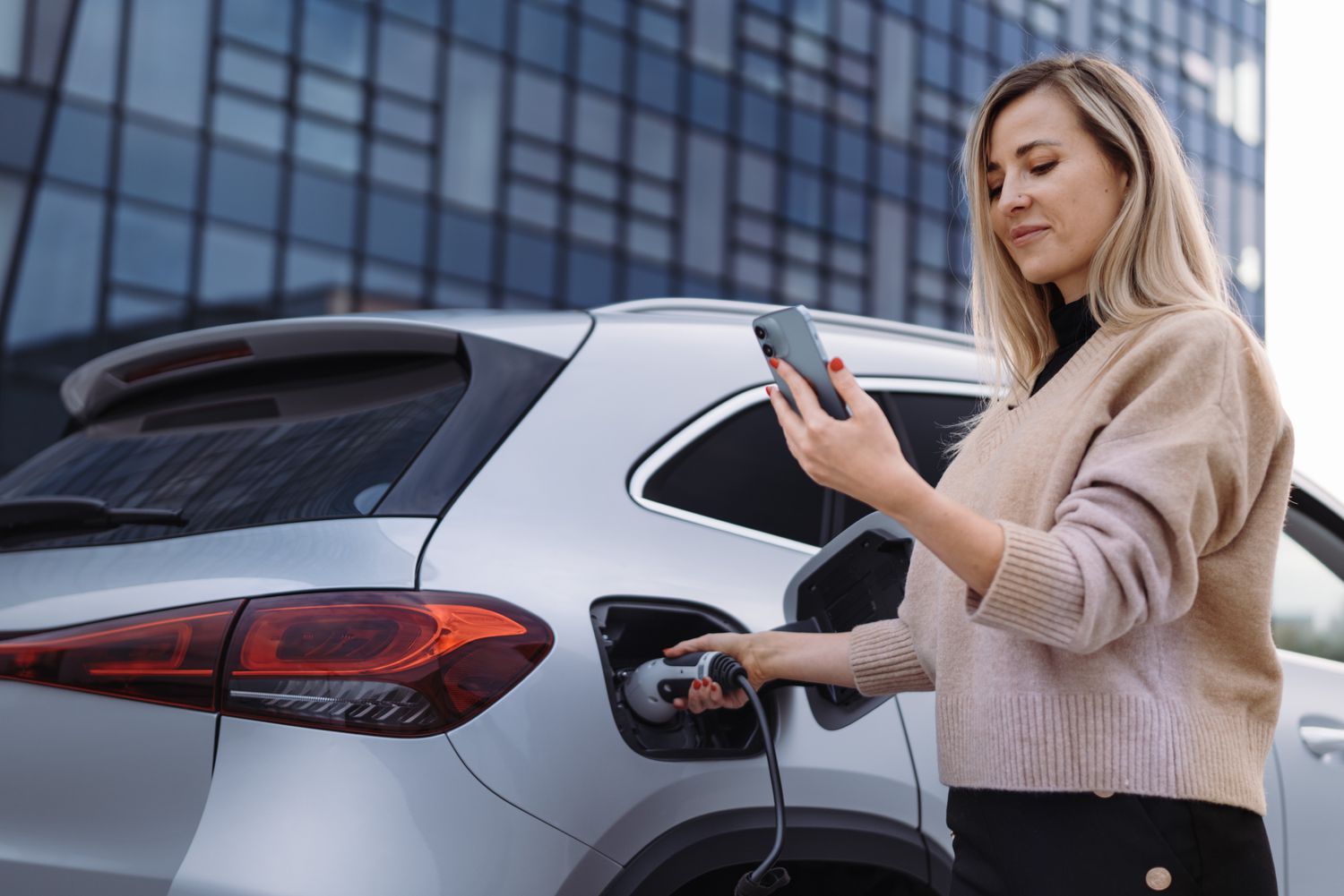 A woman charging an electric car