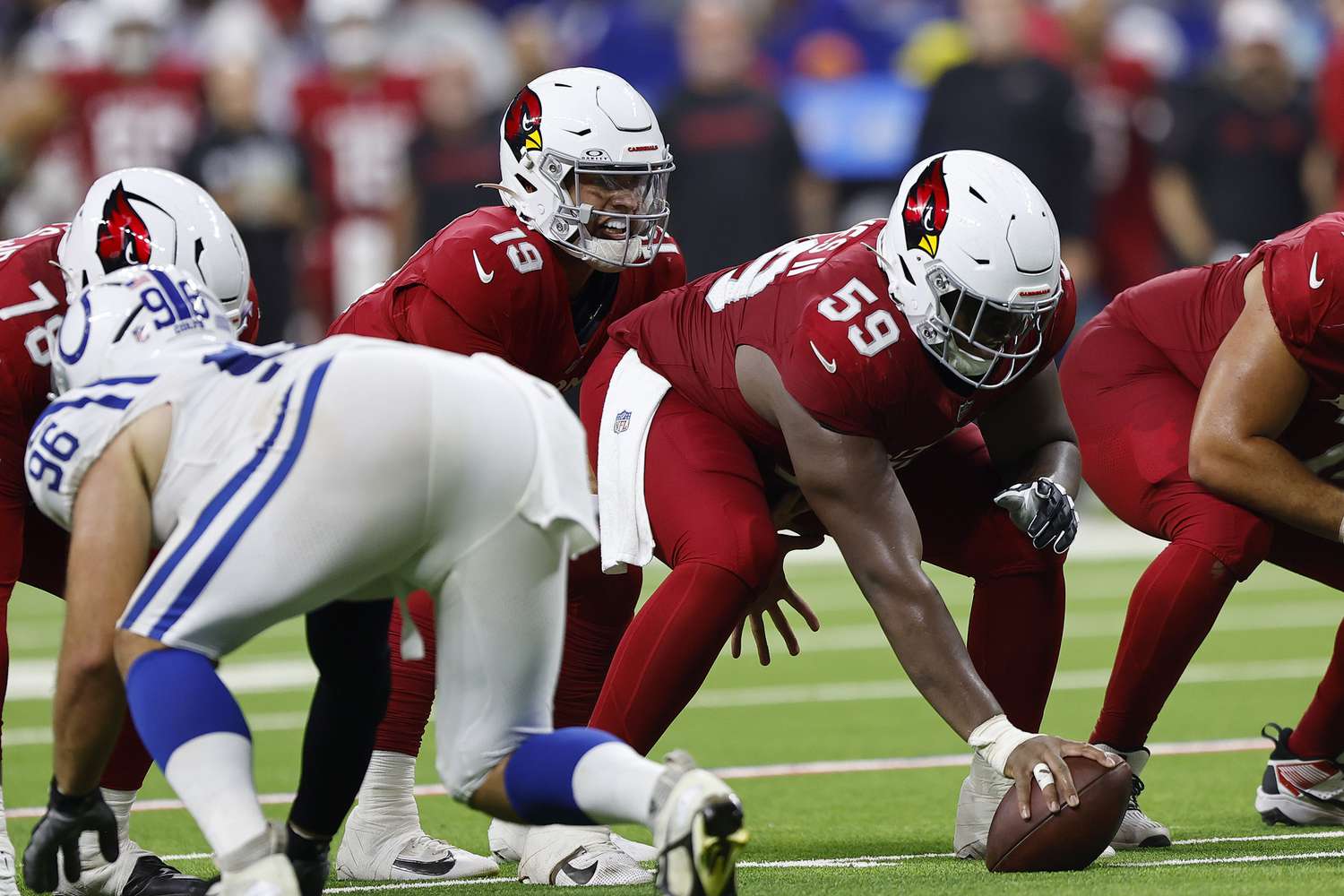 Arizona Cardinals guard Jon Gaines II (59) prepares to snap the ball to Arizona Cardinals quarterback Desmond Ridder (19) during the NFL Preseason game between the Arizona Cardinals and the Indianapolis Colts on August 17, 2024 at Lucas Oil Stadium in Indianapolis