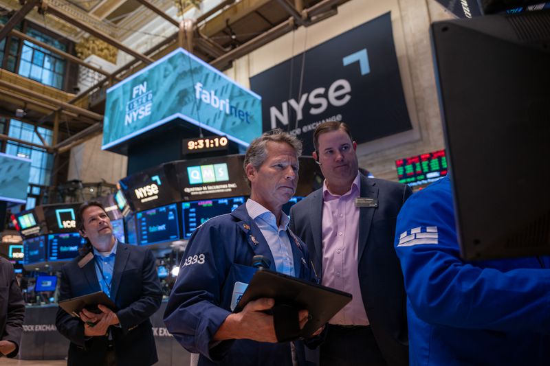 Traders work on the floor of the New York Stock Exchange (NYSE) on May 13, 2025 in New York City. 