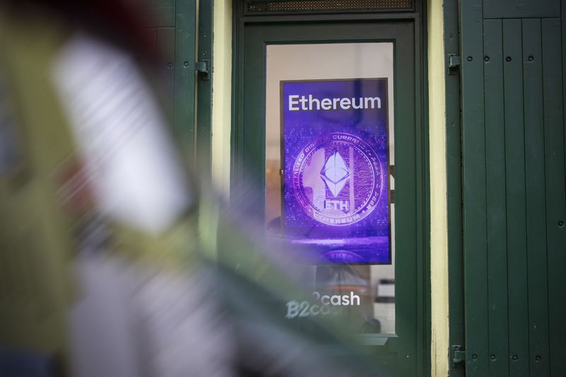 An Ethereum logo appears on a sign in the window of a cryptocurrency exchange office