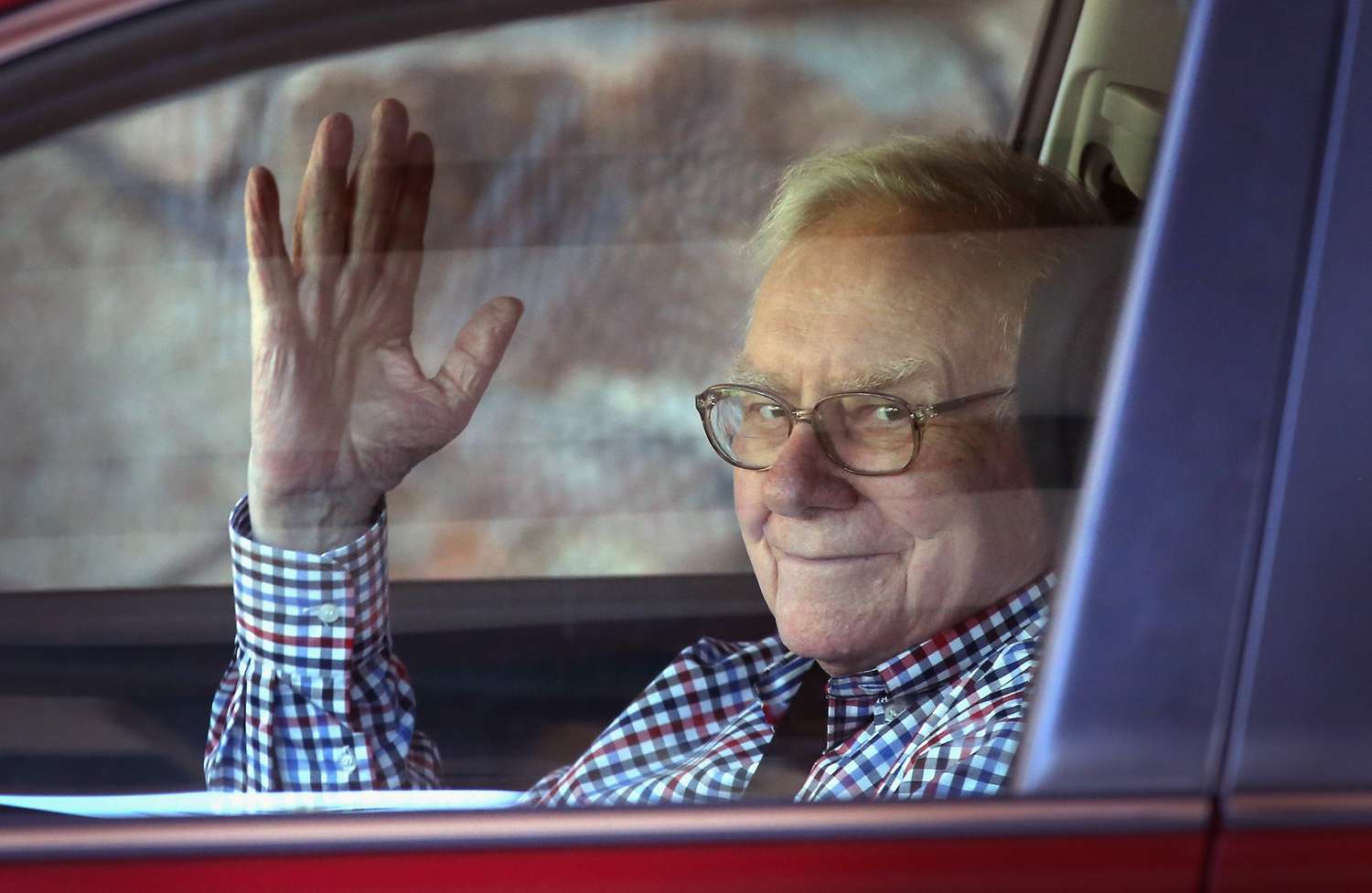 Warren Buffett waving from his car in an undated photo.