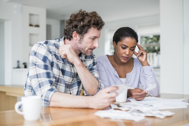 Couple looks over their finances after getting a loan from a loan shark