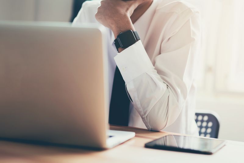 A high angle view of businessman using laptop at table.