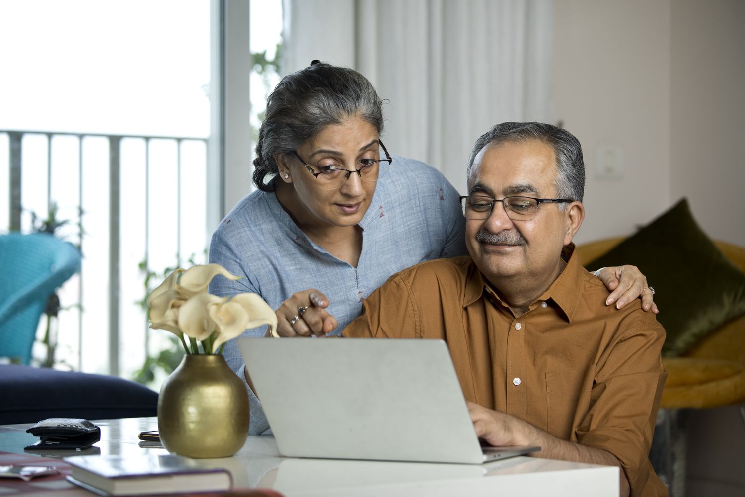 Senior couple looking together at laptop