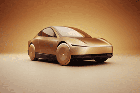 Tesla's autonomous taxi is seen in front of a light brown background