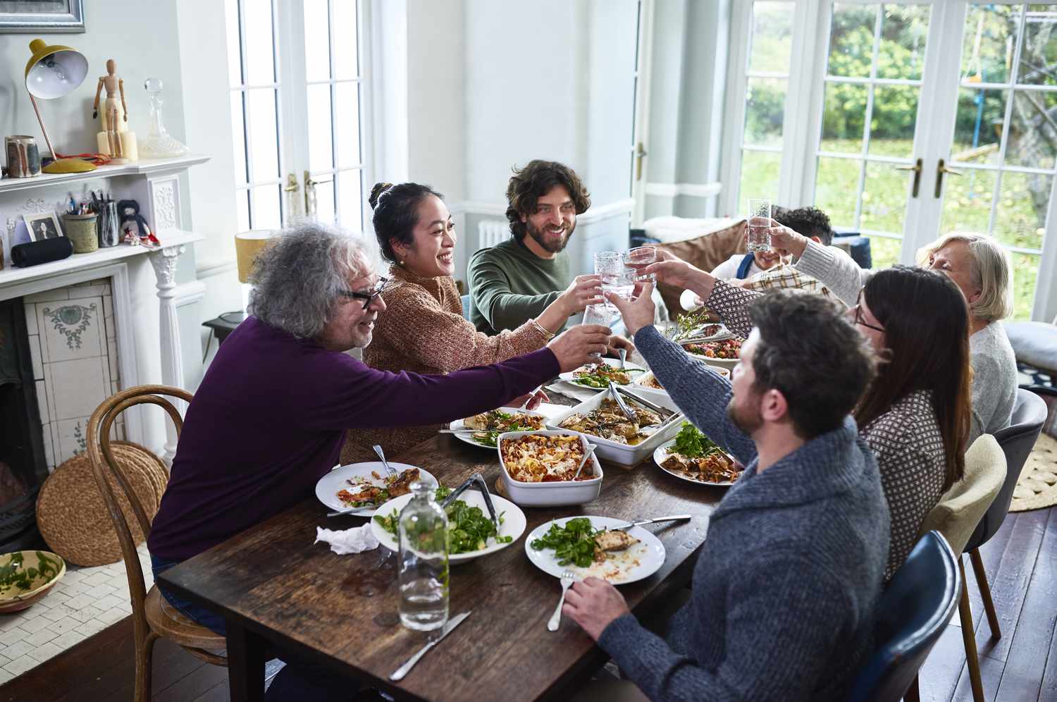 Parents and children toasting in a family dinner.