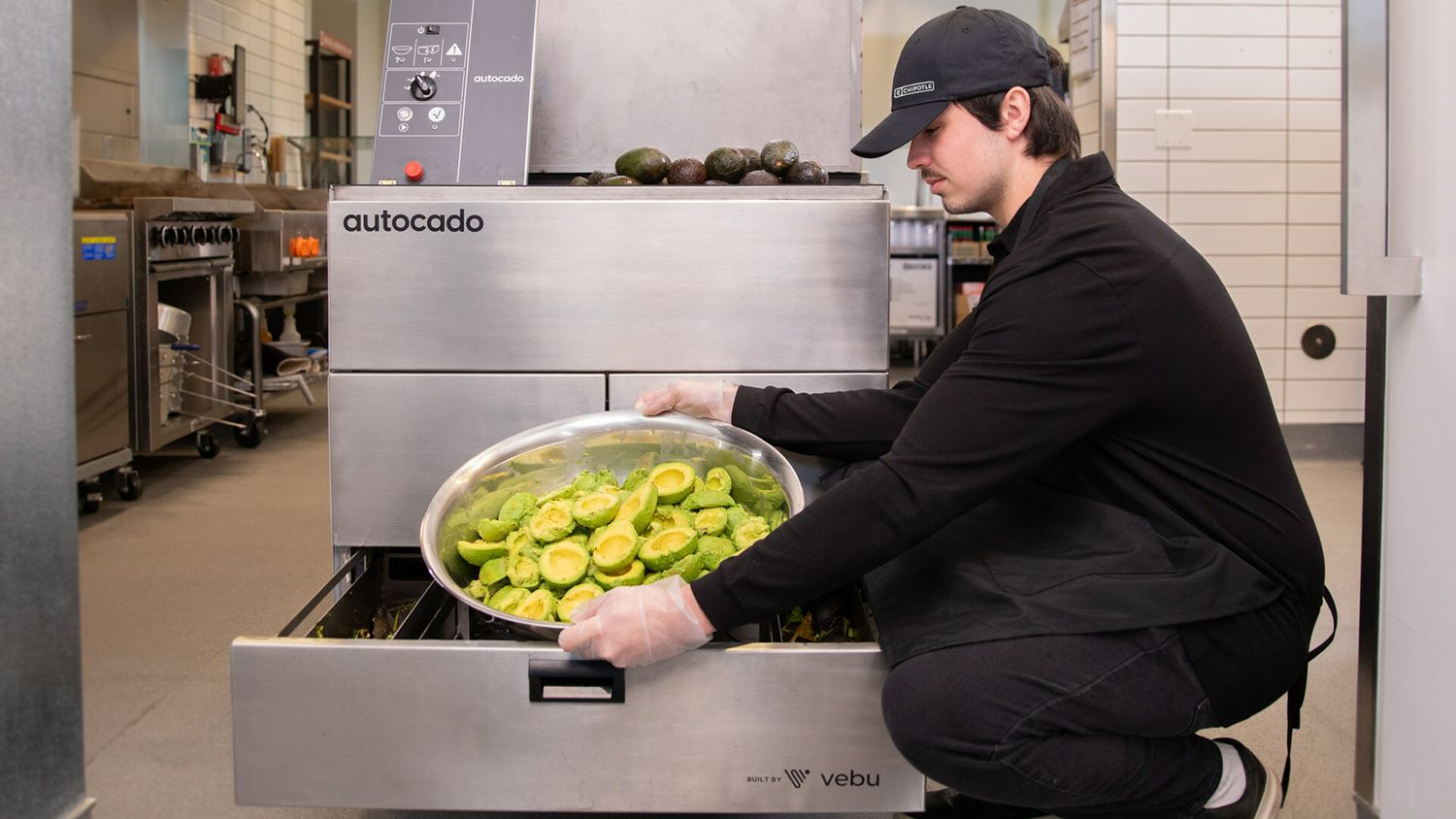 A Chipotle worker uses the company's "Autocado" machine. 