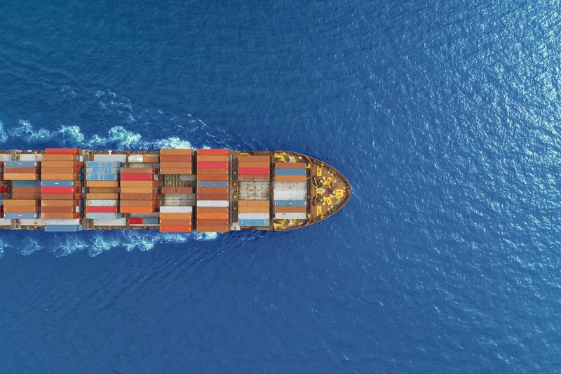 Aerial view of a container ship in the ocean.