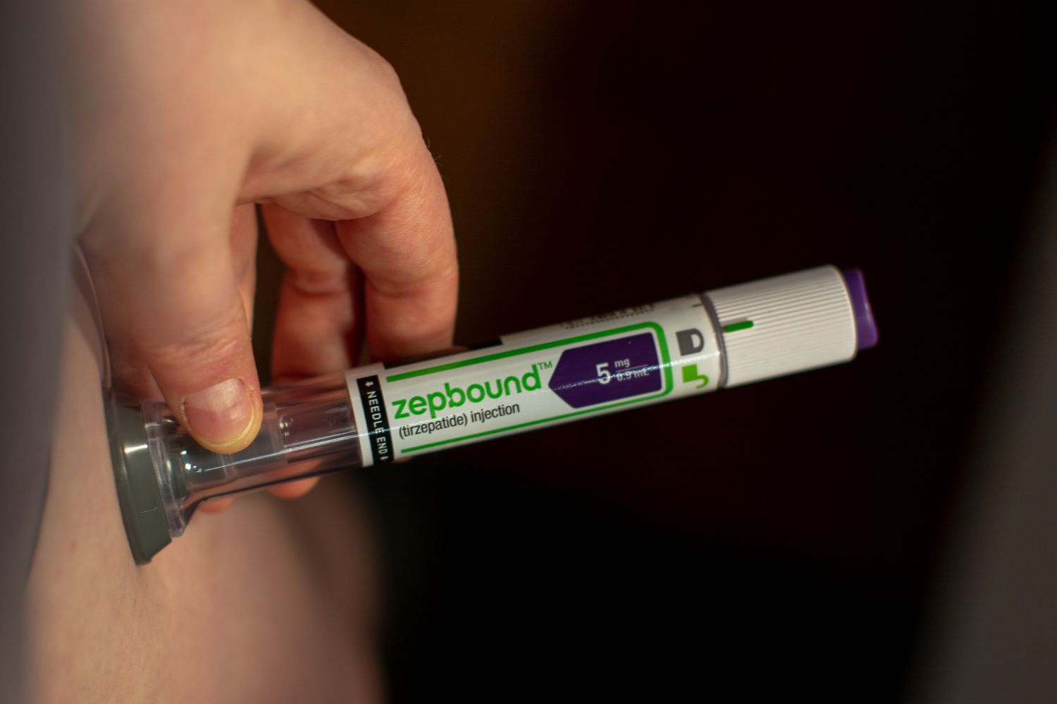 Close-up of a patient using an Eli Lilly & Co. Zepbound injection pen.