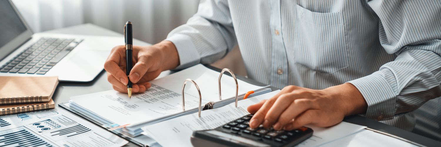A financial advisor performing some calculations at a desk.