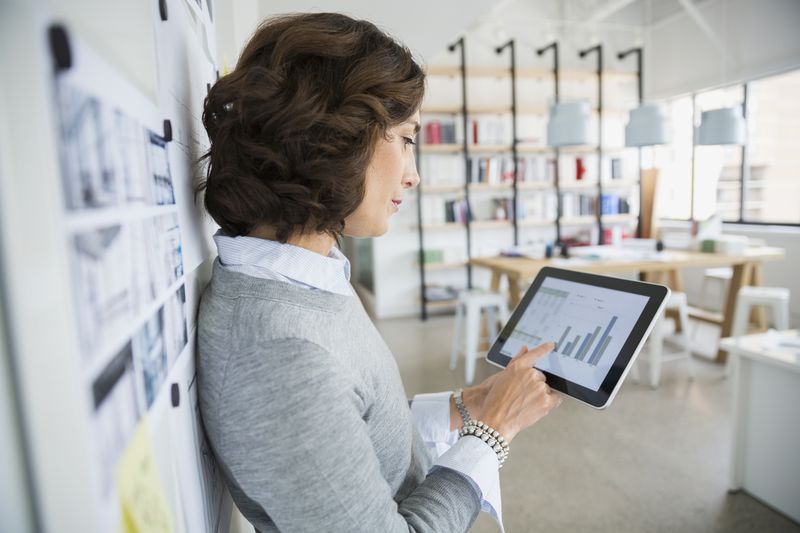 A woman evaluates her credit mix on a tablet computer.