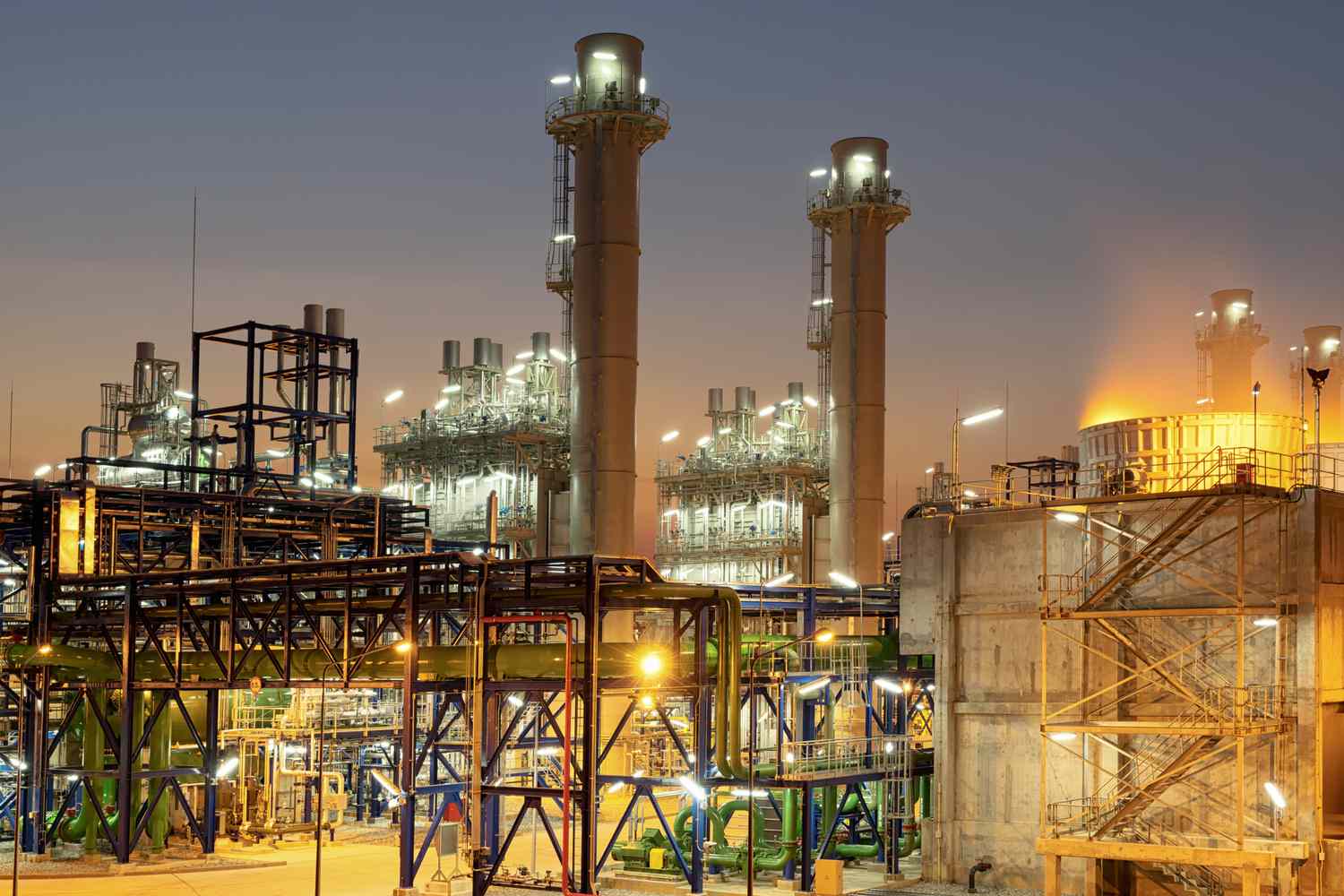 Concept Pollution and industrialization . Details of oil pipelines with valves in large oil refineries, in sunrise time refining equipment, close-up of industrial pipelines of oil refineries.