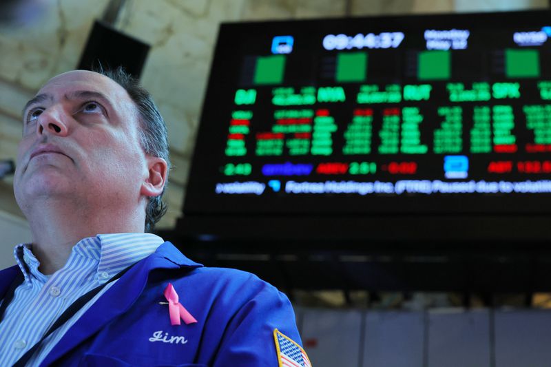 Traders work on the floor of the New York Stock Exchange during morning trading on May 12, 2025 in New York City. 