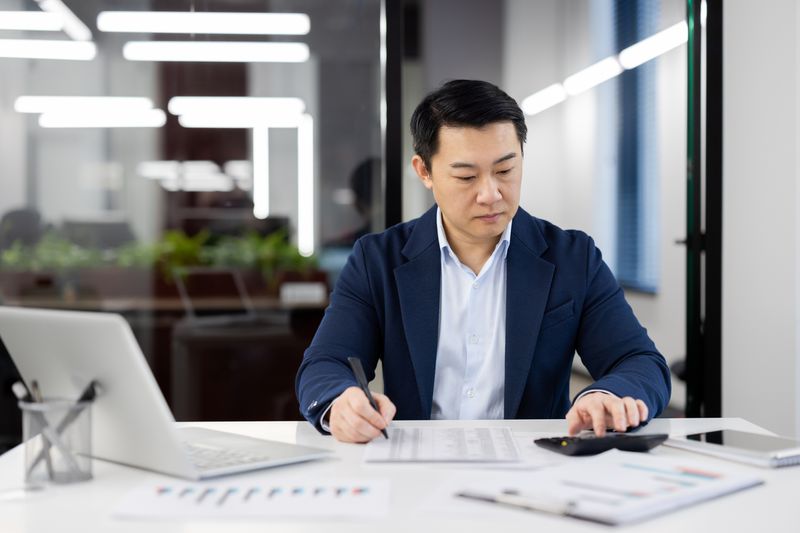 A businessman reviewing papers in an office