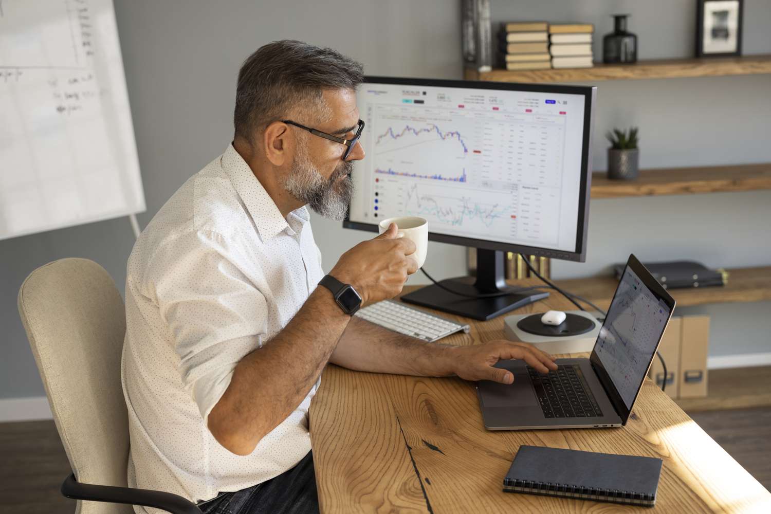 Investor sipping coffee at the table while deciding which holdings to sell to gain favorable tax treatment.