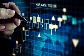 A businessman analyzing a screen with stock market graph.