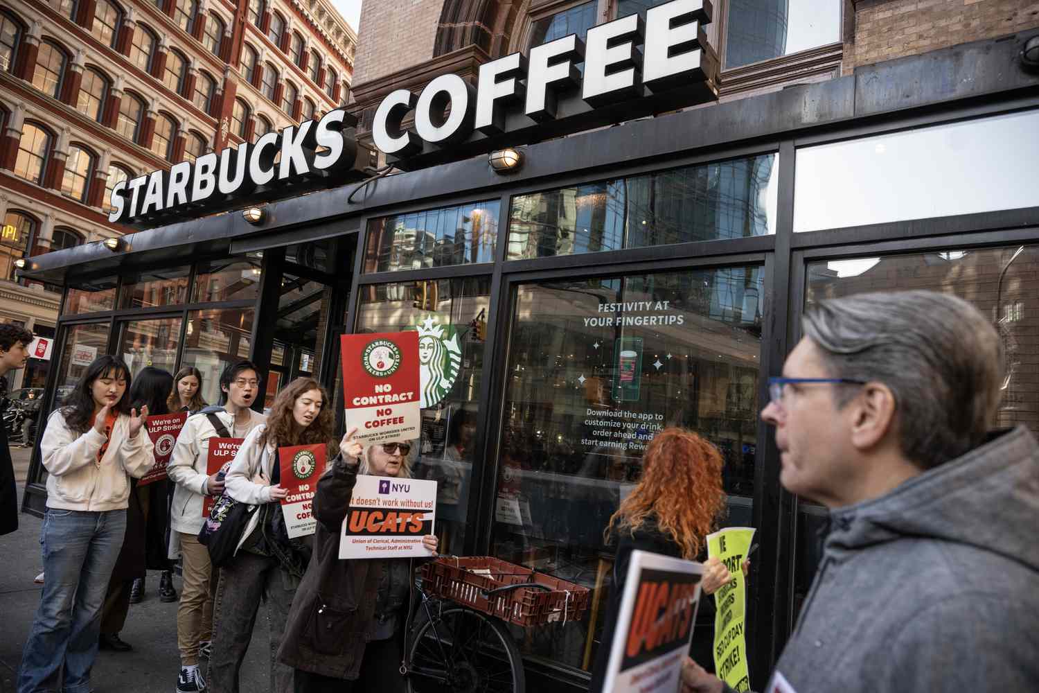 Starbucks workers on strike outside of one of the company's stores.