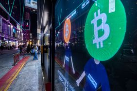 Bitcoin logos on a screen in Hong Kong, China, on Tuesday, Dec. 5, 2023.