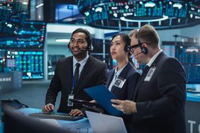 Three traders looking at a screen in an Exchange