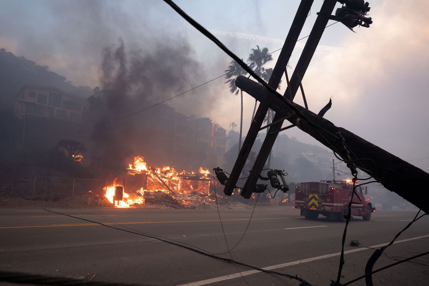 A downed power line near beachfront homes destroyed in Malibu, California, on January 8, 2025.