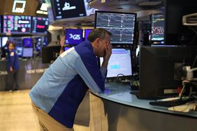 Traders work on the floor of the New York Stock Exchange