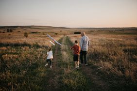Grandfather and grandchildren in a meadow