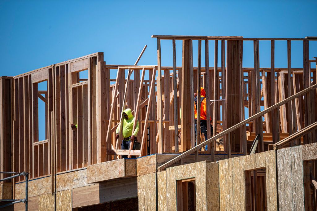 Contractors work on a house under contruction in Sacramento, California, US, on Monday, July 3, 2023.