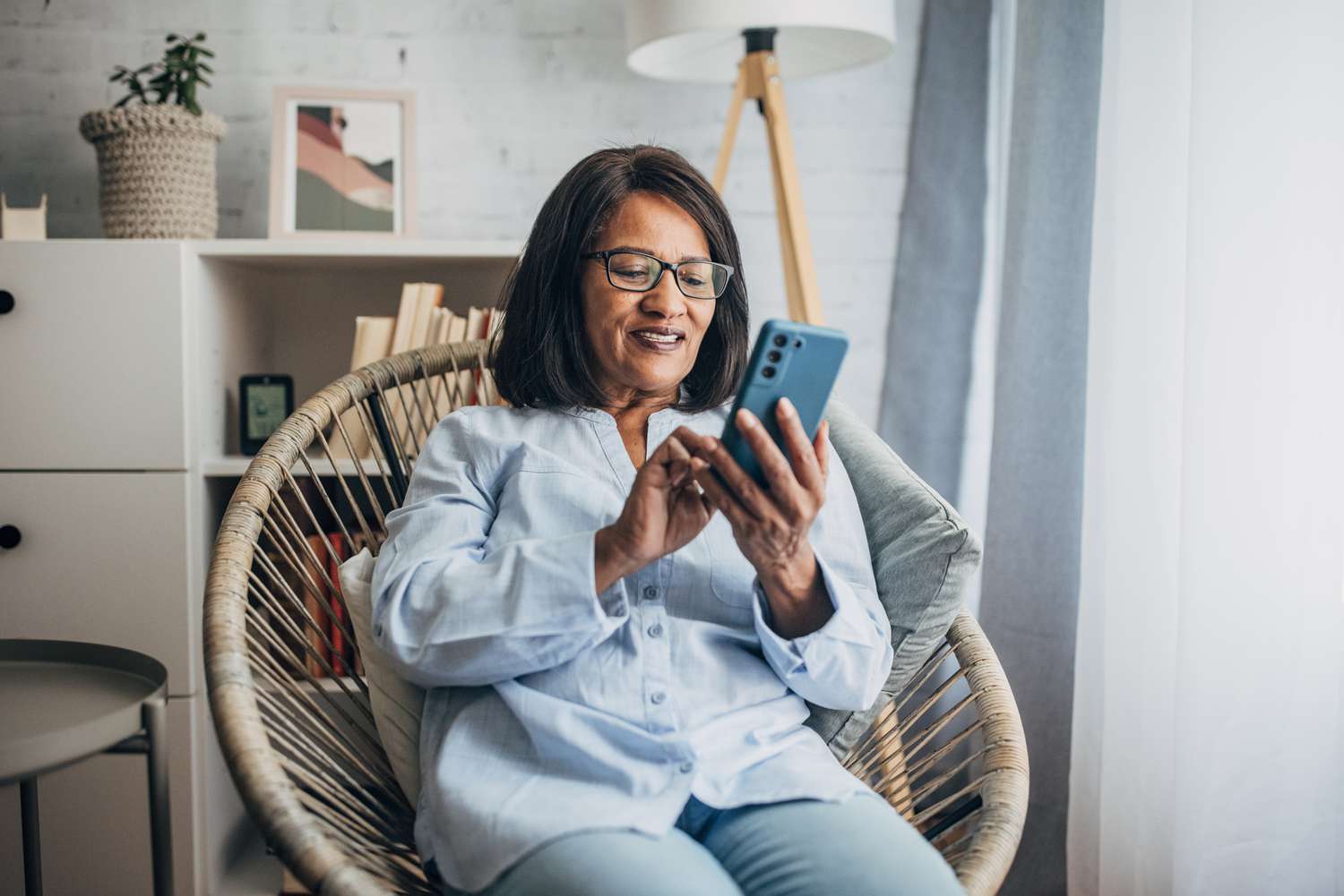 Older woman in living room with smartphone
