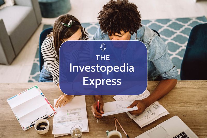 Two people sitting at a table and looking at their finances on paper