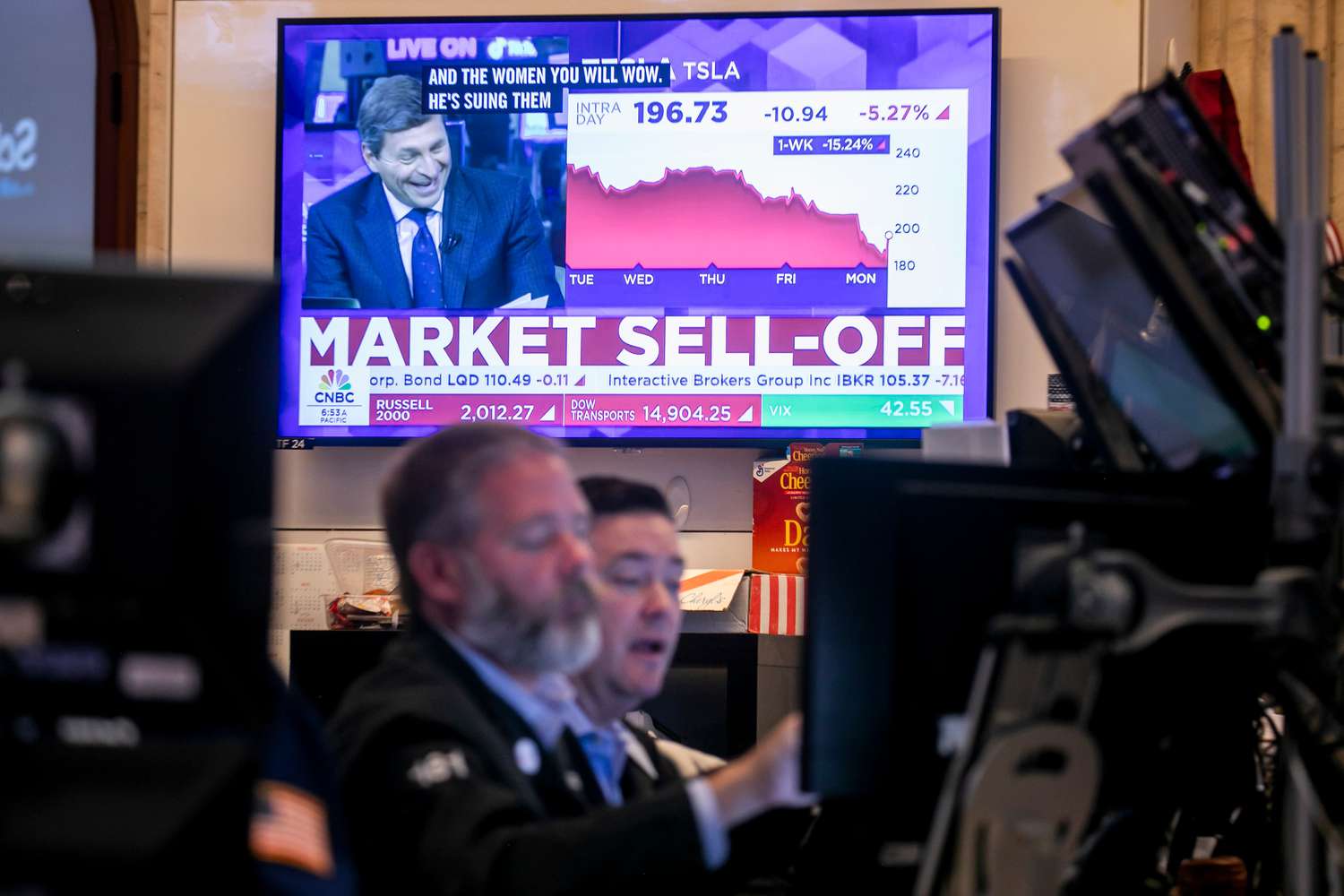 A television displays stock market news on the floor of the New York Stock Exchange (NYSE) in New York on Monday