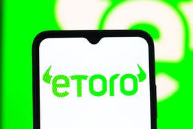 The eToro logo is seen displayed on a smartphone screen.