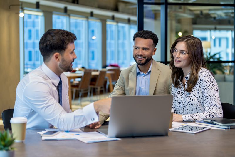 Financial advisor explains to a couple of homeowner about the concept of first mortgage.